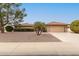 Charming single-story home featuring low-maintenance landscaping and a two-car garage at 9946 W Willow Creek Cir, Sun City, AZ 85373