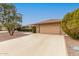 Spacious two-car garage with driveway and a charming landscaped front yard at 9946 W Willow Creek Cir, Sun City, AZ 85373