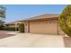 Spacious two-car garage with driveway and a charming landscaped front yard at 9946 W Willow Creek Cir, Sun City, AZ 85373