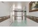 Hallway featuring tile floors, neutral wall paint, and passage into the living room at 9946 W Willow Creek Cir, Sun City, AZ 85373