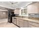 Well-lit kitchen with granite countertops, stainless steel appliances, and ample counter space for meal prep at 9946 W Willow Creek Cir, Sun City, AZ 85373