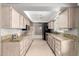 Galley kitchen featuring granite countertops, stainless steel appliances, and plenty of cabinet space at 9946 W Willow Creek Cir, Sun City, AZ 85373