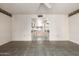 An airy living room featuring tile flooring and a passage into other rooms at 9946 W Willow Creek Cir, Sun City, AZ 85373