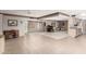 Bright living room with open layout, tile flooring, and a charming piano, perfect for entertaining at 9946 W Willow Creek Cir, Sun City, AZ 85373