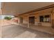 Covered patio features interlocking brick, ornate front doors and desert landscaping at 9946 W Willow Creek Cir, Sun City, AZ 85373