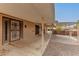 Covered patio featuring security doors, brickwork and gravel landscaping at 9946 W Willow Creek Cir, Sun City, AZ 85373