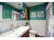 Stylish bathroom with green walls, large mirror, and vanity at 120 E Coronado Rd # 9, Phoenix, AZ 85004