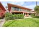 Charming two-story building with a manicured lawn and beautiful landscaping under a blue sky at 120 E Coronado Rd # 9, Phoenix, AZ 85004