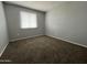 Clean, carpeted bedroom with a large window providing natural light at 1210 E Marny Rd, Tempe, AZ 85288