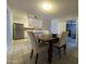 Bright dining area with a wooden table and chairs next to an updated kitchen with stainless steel appliances at 1210 E Marny Rd, Tempe, AZ 85288