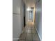 Tiled hallway with white walls that provides a sleek transition between rooms in the home at 1210 E Marny Rd, Tempe, AZ 85288