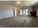 Cozy living room featuring new carpet, patio access, and a striking red fireplace at 1210 E Marny Rd, Tempe, AZ 85288