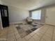 Inviting living room with tile floors, a patterned armchair, and ample natural light from a window at 1210 E Marny Rd, Tempe, AZ 85288