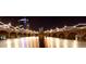 Scenic night view of a illuminated building and bridge reflecting in calm waters, creating a captivating urban landscape at 1210 E Marny Rd, Tempe, AZ 85288