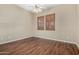 Well-lit bedroom with wood-look floors, ceiling fan, and natural light at 12852 W El Sueno Dr, Sun City West, AZ 85375