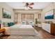 Serene bedroom featuring a ceiling fan, bay window, and stylish décor at 12852 W El Sueno Dr, Sun City West, AZ 85375