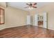 Bright bedroom with hardwood floors, ceiling fan and a view into the bathroom at 12852 W El Sueno Dr, Sun City West, AZ 85375