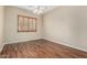 Bedroom featuring wood-look floors, ceiling fan, and shuttered window at 12852 W El Sueno Dr, Sun City West, AZ 85375