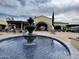 Clubhouse exterior with outdoor seating area and a water fountain at 12852 W El Sueno Dr, Sun City West, AZ 85375