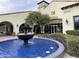 Clubhouse exterior featuring a fountain, and arched entrance with a terracotta tile roof at 12852 W El Sueno Dr, Sun City West, AZ 85375