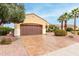 Home exterior with a two car garage, desert landscaping with a variety of plants and trees at 12852 W El Sueno Dr, Sun City West, AZ 85375