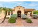 Inviting home entrance with an arched doorway and manicured desert landscaping at 12852 W El Sueno Dr, Sun City West, AZ 85375