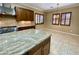 A kitchen area showcases stainless appliances, granite counters, and natural wood cabinets and window shutters at 12852 W El Sueno Dr, Sun City West, AZ 85375