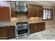 Updated kitchen features stainless-steel appliances, granite countertops and custom wood cabinetry at 12852 W El Sueno Dr, Sun City West, AZ 85375