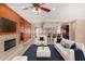 Inviting living room with fireplace, ceiling fan, and bar seating to the kitchen at 12852 W El Sueno Dr, Sun City West, AZ 85375