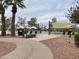 Community pool area featuring lounge chairs, shade umbrellas, and mature palm trees at 12852 W El Sueno Dr, Sun City West, AZ 85375