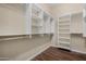 Walk-in closet with built-in shelving and hardwood floors at 12852 W El Sueno Dr, Sun City West, AZ 85375