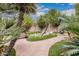 The backyard is a tranquil retreat with lush greenery, decorative stone and dolphin sculpture at 12955 E Mercer Ln, Scottsdale, AZ 85259