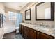 Stylish bathroom with double vanity, granite countertop, wood cabinets and a tub/shower combo at 12955 E Mercer Ln, Scottsdale, AZ 85259