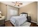 Comfortable bedroom featuring wood floors, a ceiling fan, and great natural light at 12955 E Mercer Ln, Scottsdale, AZ 85259