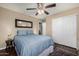 Comfortable bedroom featuring a ceiling fan, closet, and stylish rug at 12955 E Mercer Ln, Scottsdale, AZ 85259