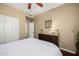 Bright bedroom featuring wood floors, a dresser, and ample closet space at 12955 E Mercer Ln, Scottsdale, AZ 85259