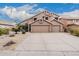 Spacious home with a wide driveway and desert landscaping under a blue sky at 12955 E Mercer Ln, Scottsdale, AZ 85259