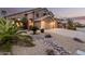 Expansive front yard with desert landscaping and a view of the home's facade at 12955 E Mercer Ln, Scottsdale, AZ 85259