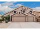 Two-story home featuring a three car garage and a neutral desert color scheme at 12955 E Mercer Ln, Scottsdale, AZ 85259