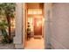 Covered entryway featuring a decorative front door and manicured plants at 12955 E Mercer Ln, Scottsdale, AZ 85259