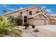 Up close, the desert landscaping includes rocks, gravel, small plants, and palm trees at 12955 E Mercer Ln, Scottsdale, AZ 85259