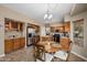 Well-equipped kitchen with stainless steel appliances, wood cabinetry, granite countertops, and a casual dining area at 12955 E Mercer Ln, Scottsdale, AZ 85259