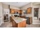 Well-lit kitchen featuring granite counters, an island, and stainless steel appliances at 12955 E Mercer Ln, Scottsdale, AZ 85259