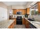 This kitchen features granite countertops, wood cabinets, and stainless steel appliances at 12955 E Mercer Ln, Scottsdale, AZ 85259