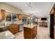 Open-concept kitchen with stainless steel appliances, granite countertops, a breakfast bar, and views to living area at 12955 E Mercer Ln, Scottsdale, AZ 85259