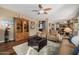 Open-concept living area with hardwood floors, a ceiling fan, and views to the kitchen at 12955 E Mercer Ln, Scottsdale, AZ 85259