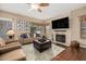 Cozy Gathering room with a stone fireplace, ceiling fan, and neutral color palette at 12955 E Mercer Ln, Scottsdale, AZ 85259