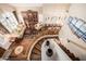 Aerial view of open-concept living room, dining room with staircase, hardwood floors and natural light at 12955 E Mercer Ln, Scottsdale, AZ 85259