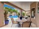 Covered patio offering a relaxing outdoor dining space with a full view of the pool and garden at 12955 E Mercer Ln, Scottsdale, AZ 85259