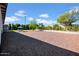 Spacious backyard featuring a well-maintained gravel and mature trees at 14446 N 40Th Pl, Phoenix, AZ 85032